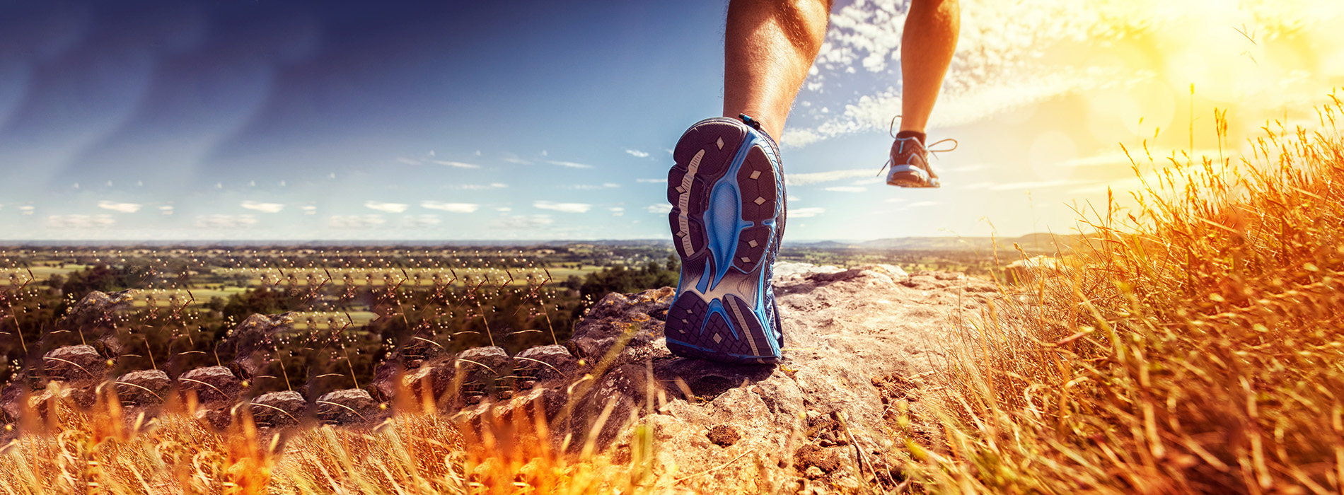 The image shows a person running on a trail with a scenic background.